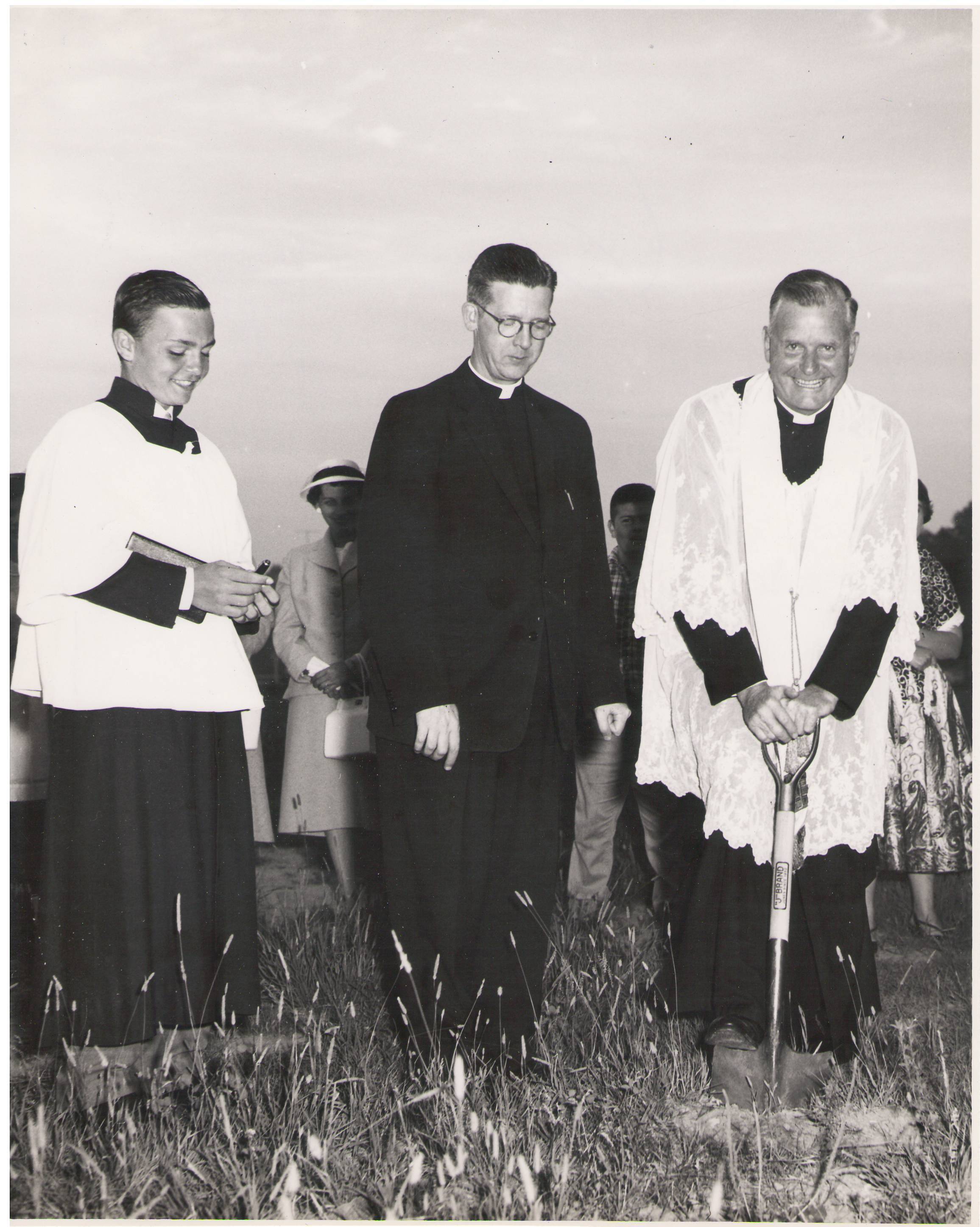 three priests turning sod